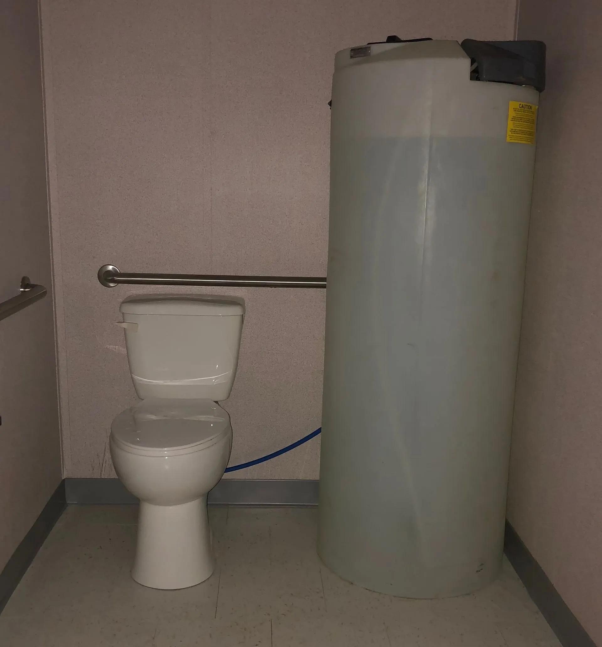 Inside view of a portable restroom trailer with gravity flush water tank
