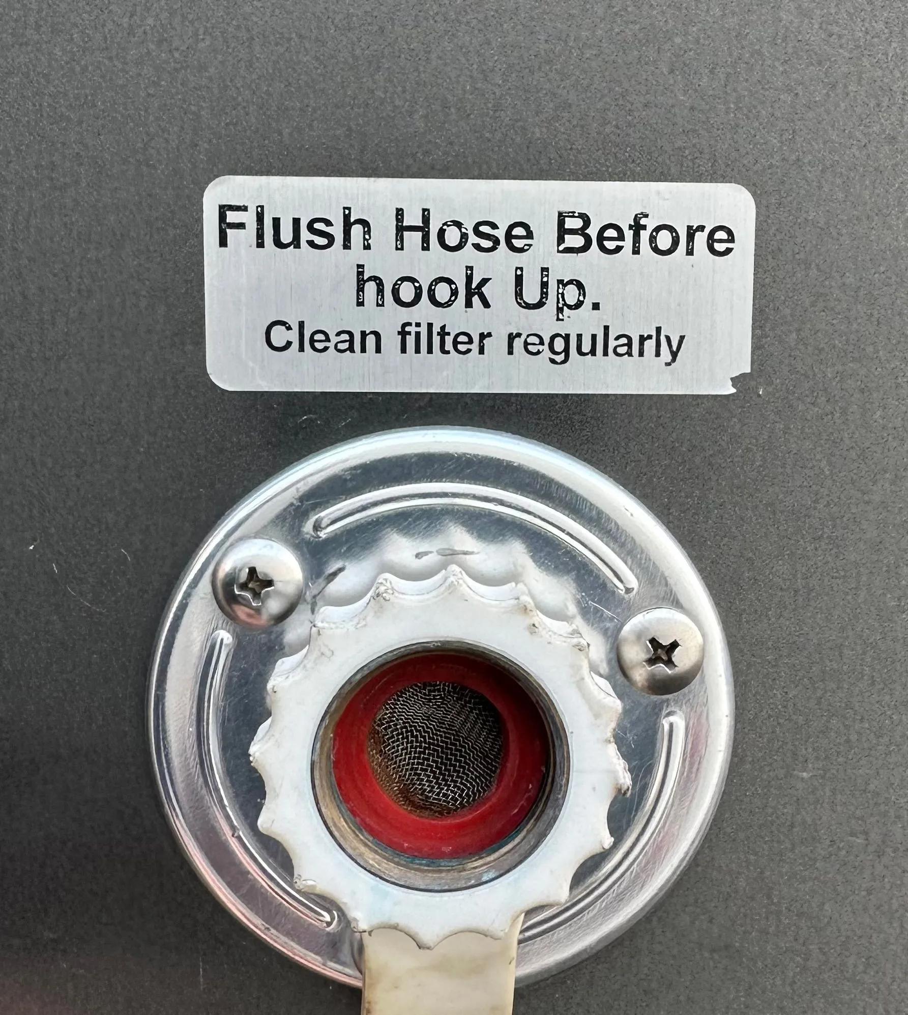 Up close view of flush hose hookup for restroom trailer