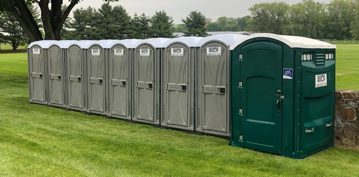 Image of a line of portable restrooms.